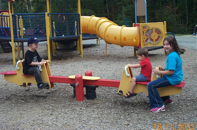 Caleb, Isaia, & Heidi on see saw